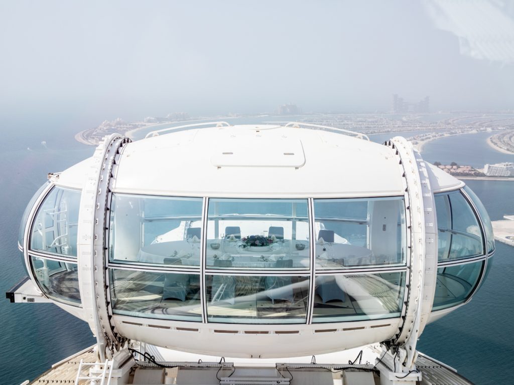 Ain Dubai pod in the sky with The Palm in background 