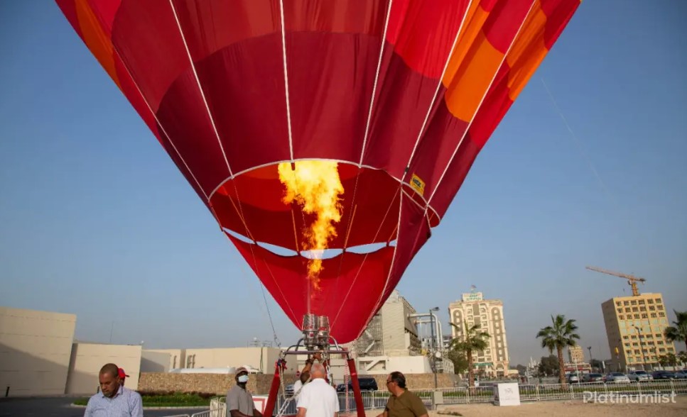 Ras Al Khaimah hot air balloon ride: red hot air balloon with fire taking off